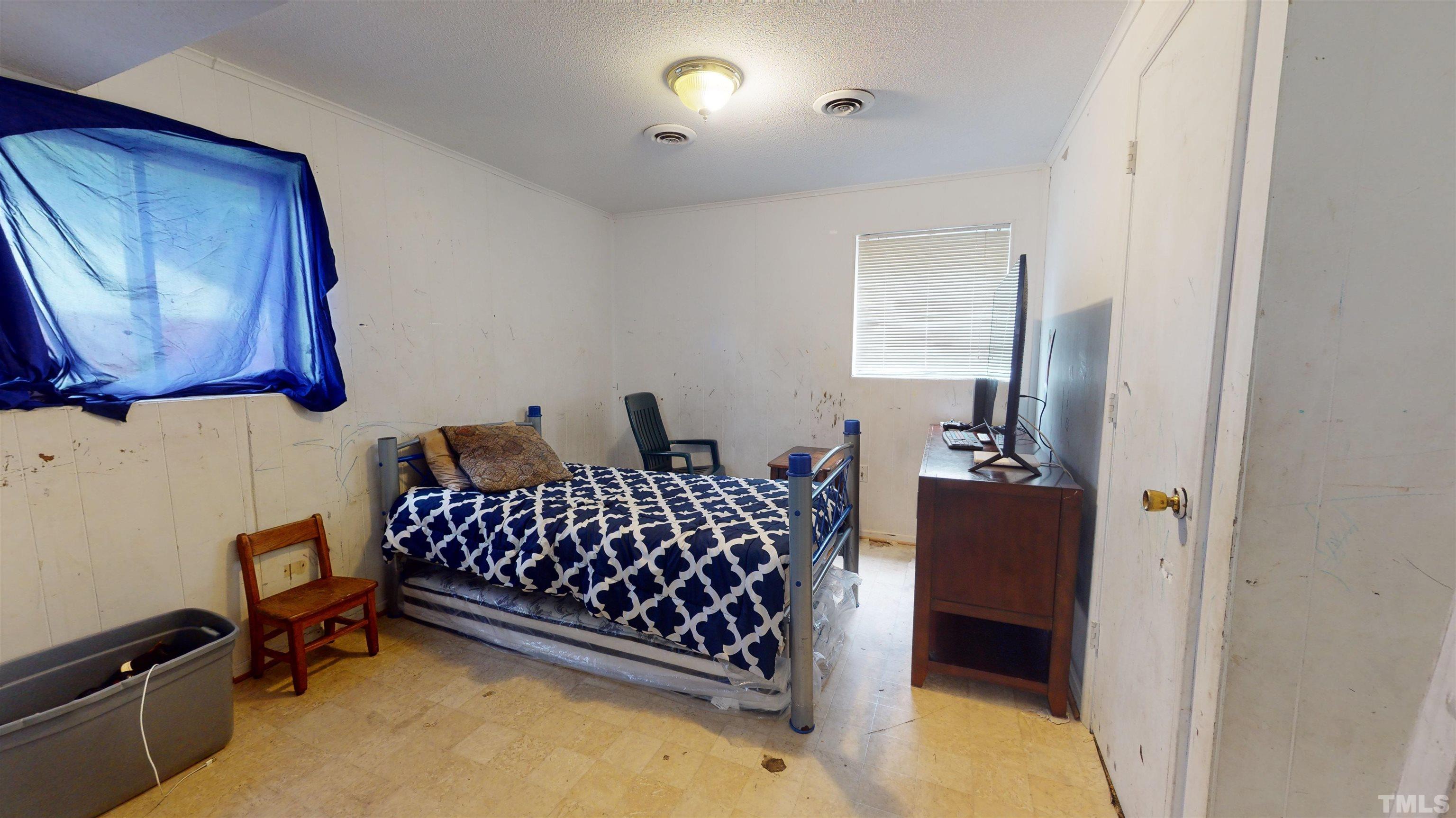 1101 Kitt Place Raleigh, NC 27610 - Photo 22 of 41 a bedroom with a bed and wooden floor