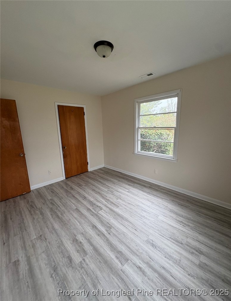 307 Elaine Street Spring Lake, NC 28390 - Photo 7 of 7 a view of an empty room with wooden floor and a window