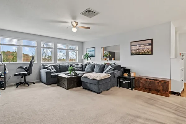 a living room with furniture and large windows