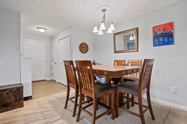 a view of a dining room with furniture and chandelier