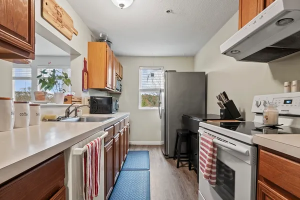 a kitchen with a sink stove and refrigerator
