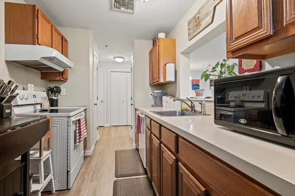 a kitchen with stainless steel appliances granite countertop a stove and cabinets