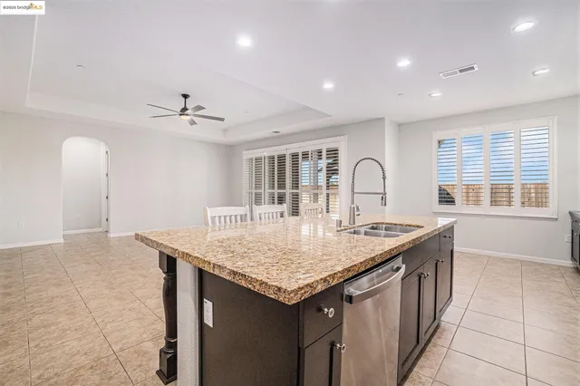 a kitchen with center island a sink stainless steel appliances and cabinets
