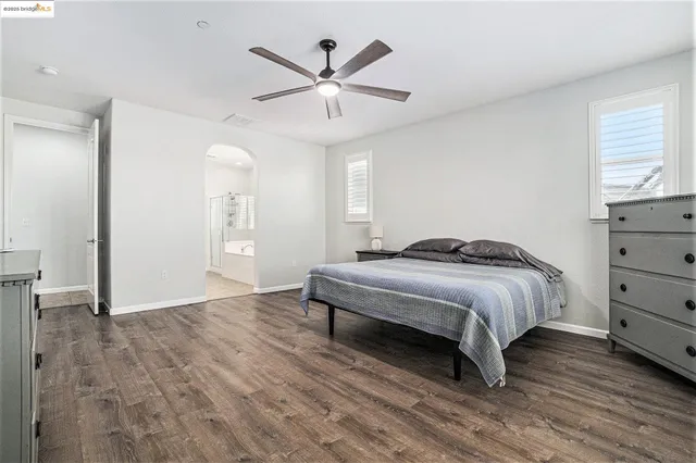 a spacious bedroom with a bed and a window