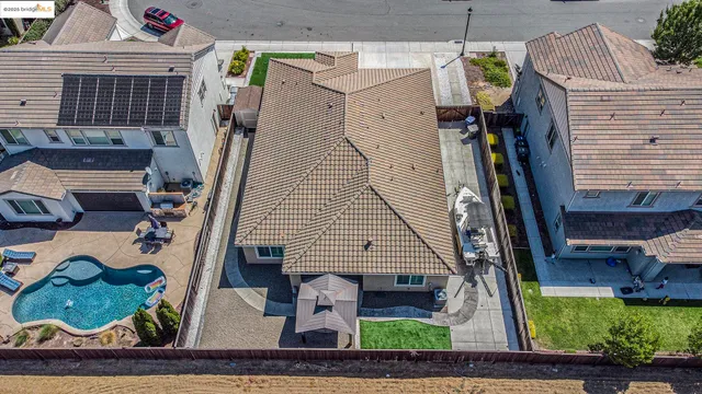 a view of street with a table and chairs under an umbrella