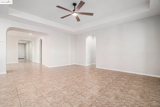 a view of a livingroom with a ceiling fan and window
