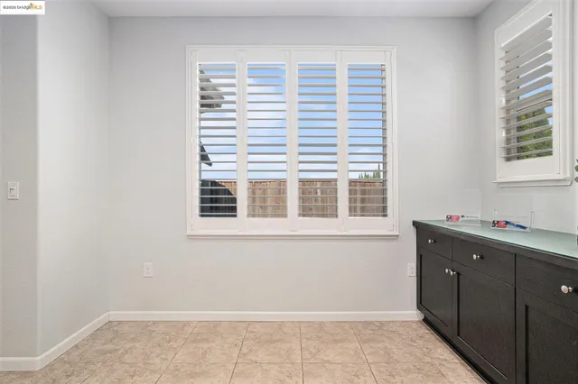 a room with a dresser and a window
