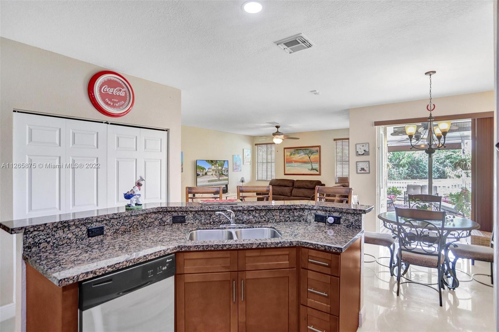 27846 Southwest 142nd Avenue Homestead, FL 33032 - Photo 15 of 56 a kitchen with stainless steel appliances granite countertop a sink and a large window