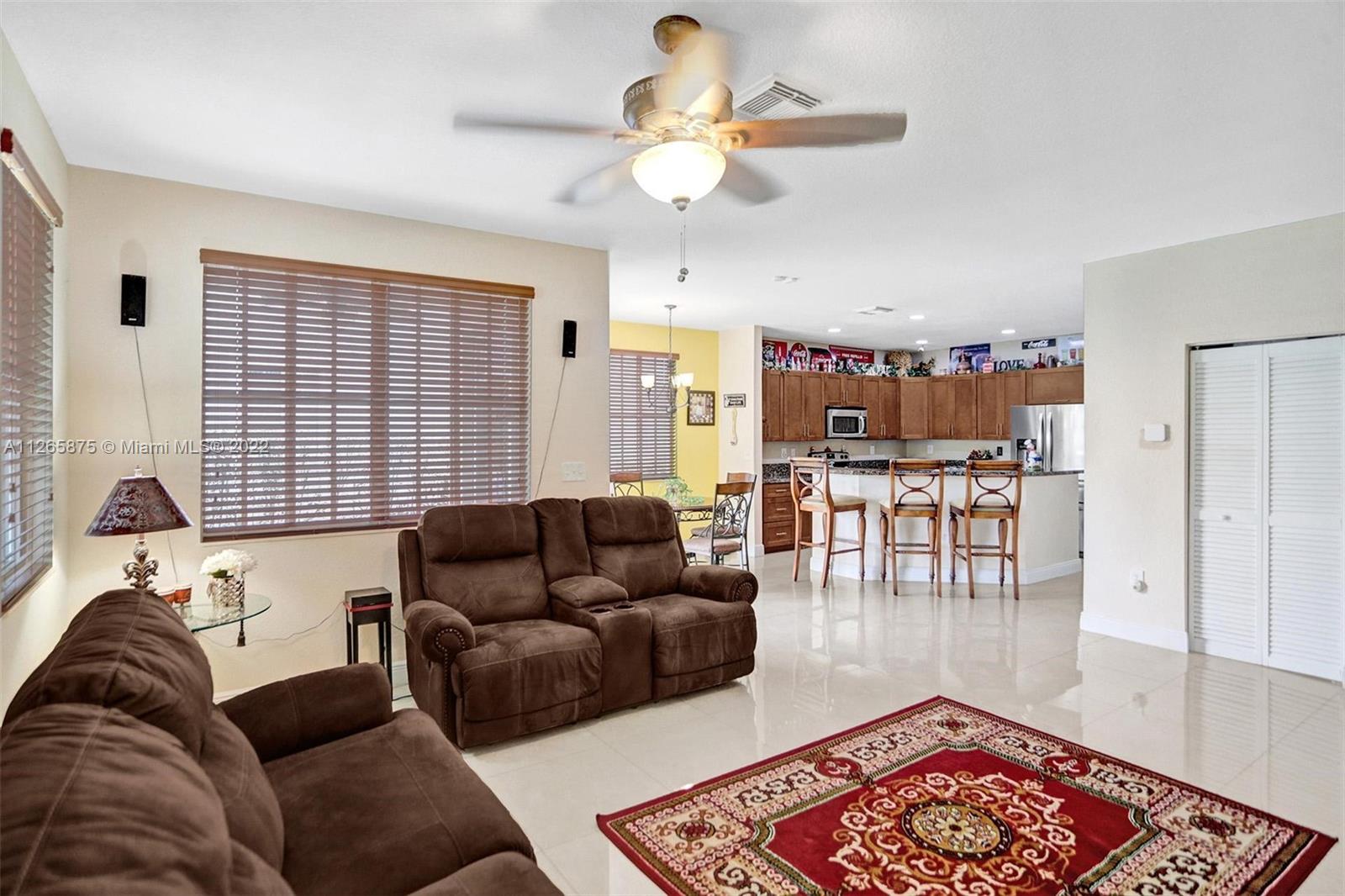 27846 Southwest 142nd Avenue Homestead, FL 33032 - Photo 16 of 56 a living room with furniture and a rug