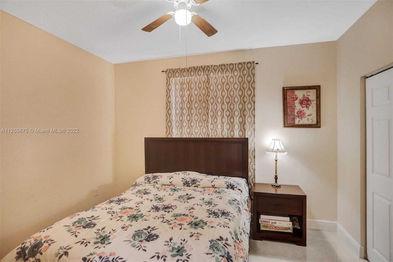 27846 Southwest 142nd Avenue Homestead, FL 33032 - Photo 20 of 56 a bedroom with a bed and a table in it