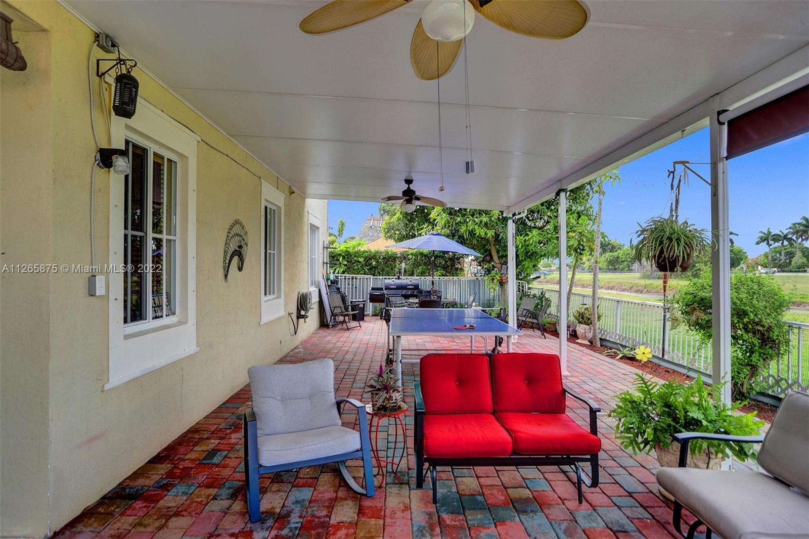 27846 Southwest 142nd Avenue Homestead, FL 33032 - Photo 22 of 56 a dining room with furniture and a floor to ceiling window