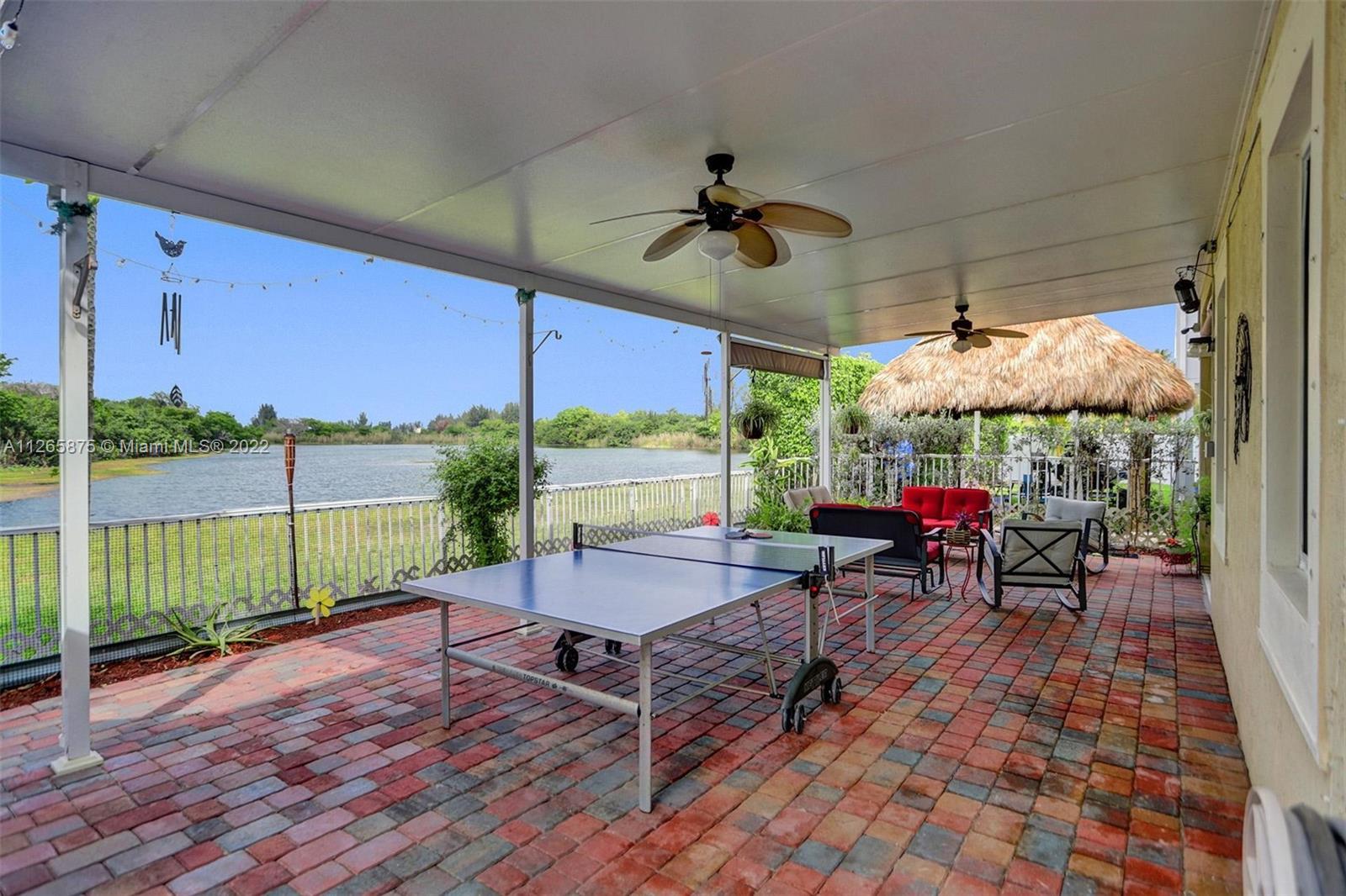 27846 Southwest 142nd Avenue Homestead, FL 33032 - Photo 25 of 56 a view of a dining room with furniture window and outside view
