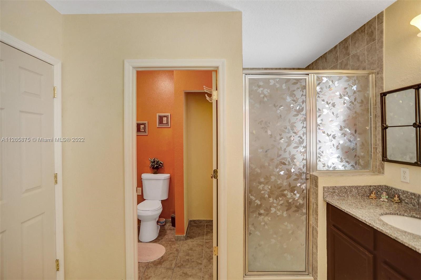 27846 Southwest 142nd Avenue Homestead, FL 33032 - Photo 42 of 56 a bathroom with a granite countertop sink a toilet and shower