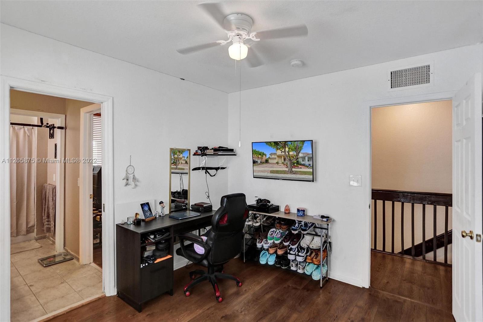 27846 Southwest 142nd Avenue Homestead, FL 33032 - Photo 44 of 56 a view of a workspace with furniture and wooden floor