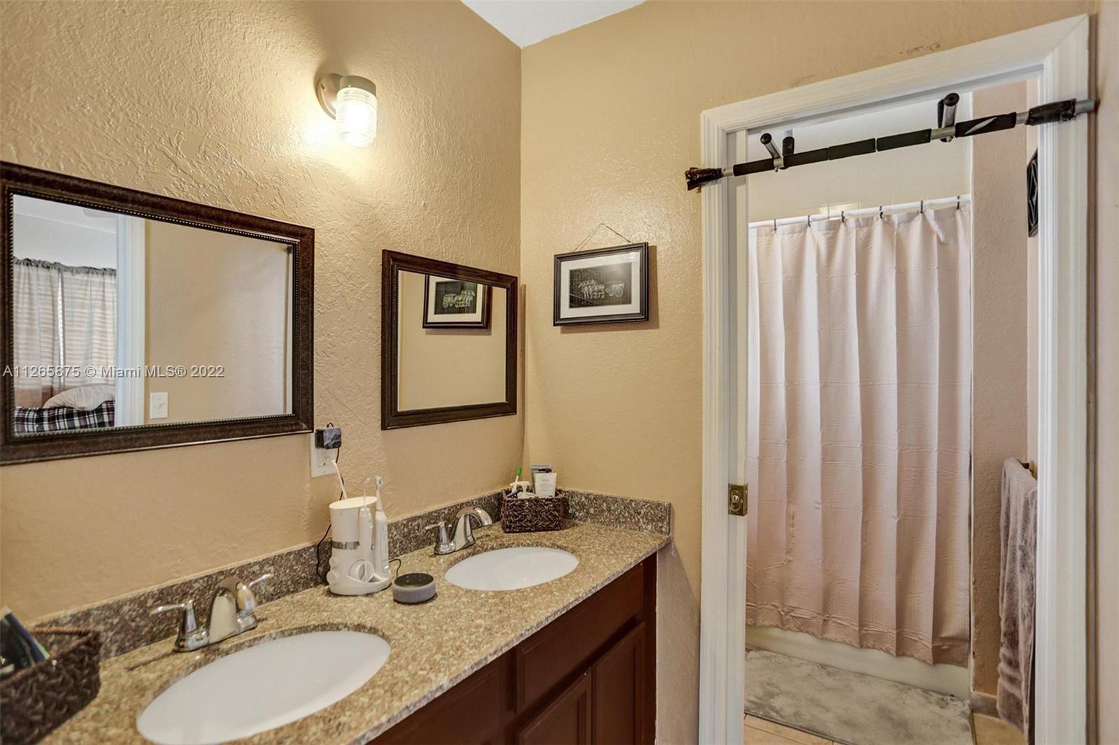 27846 Southwest 142nd Avenue Homestead, FL 33032 - Photo 45 of 56 a bathroom with a granite countertop sink and a mirror
