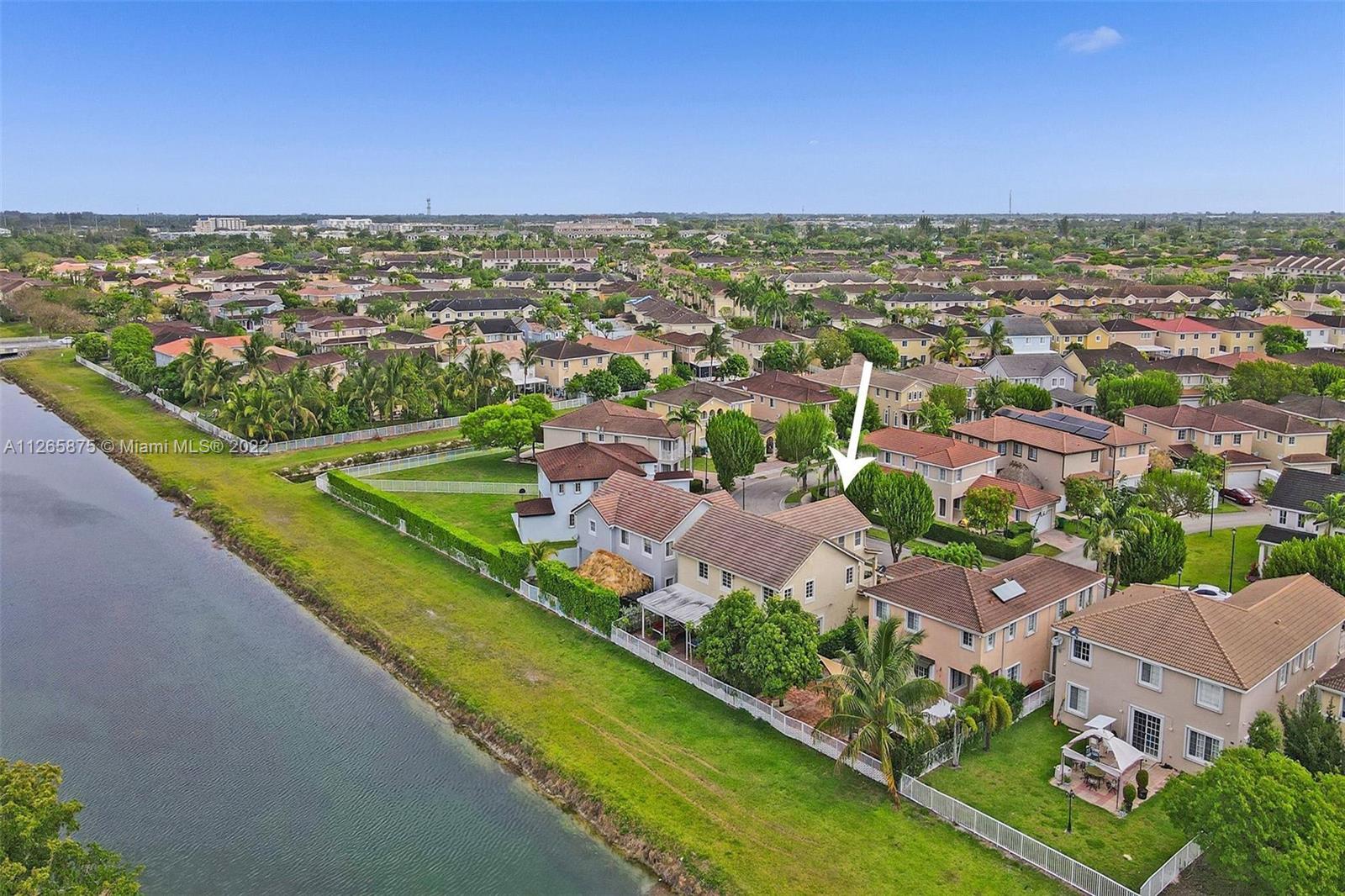 27846 Southwest 142nd Avenue Homestead, FL 33032 - Photo 52 of 56 an aerial view of residential houses with outdoor space and swimming pool