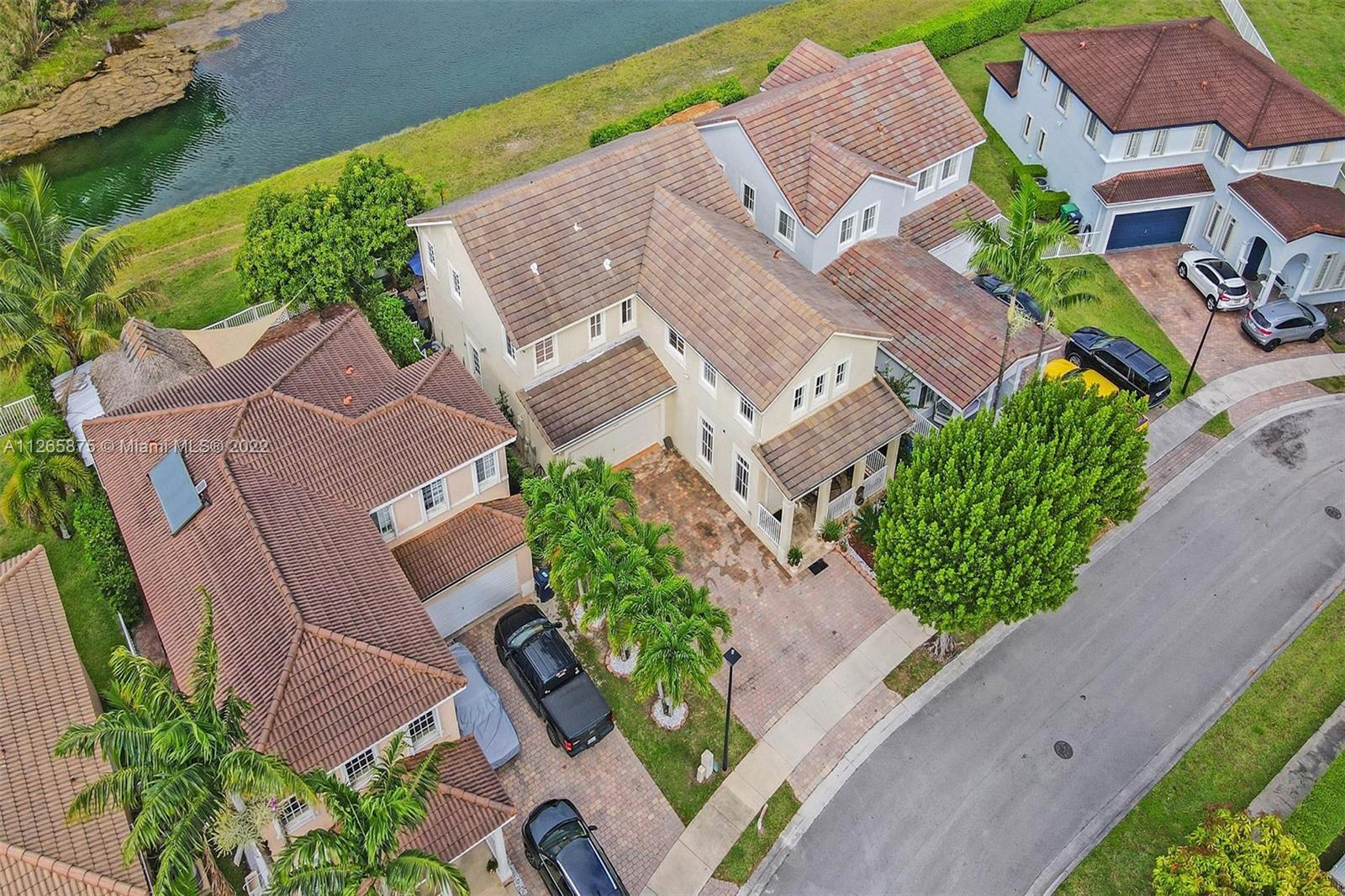 27846 Southwest 142nd Avenue Homestead, FL 33032 - Photo 54 of 56 an aerial view of a house with a yard and garden