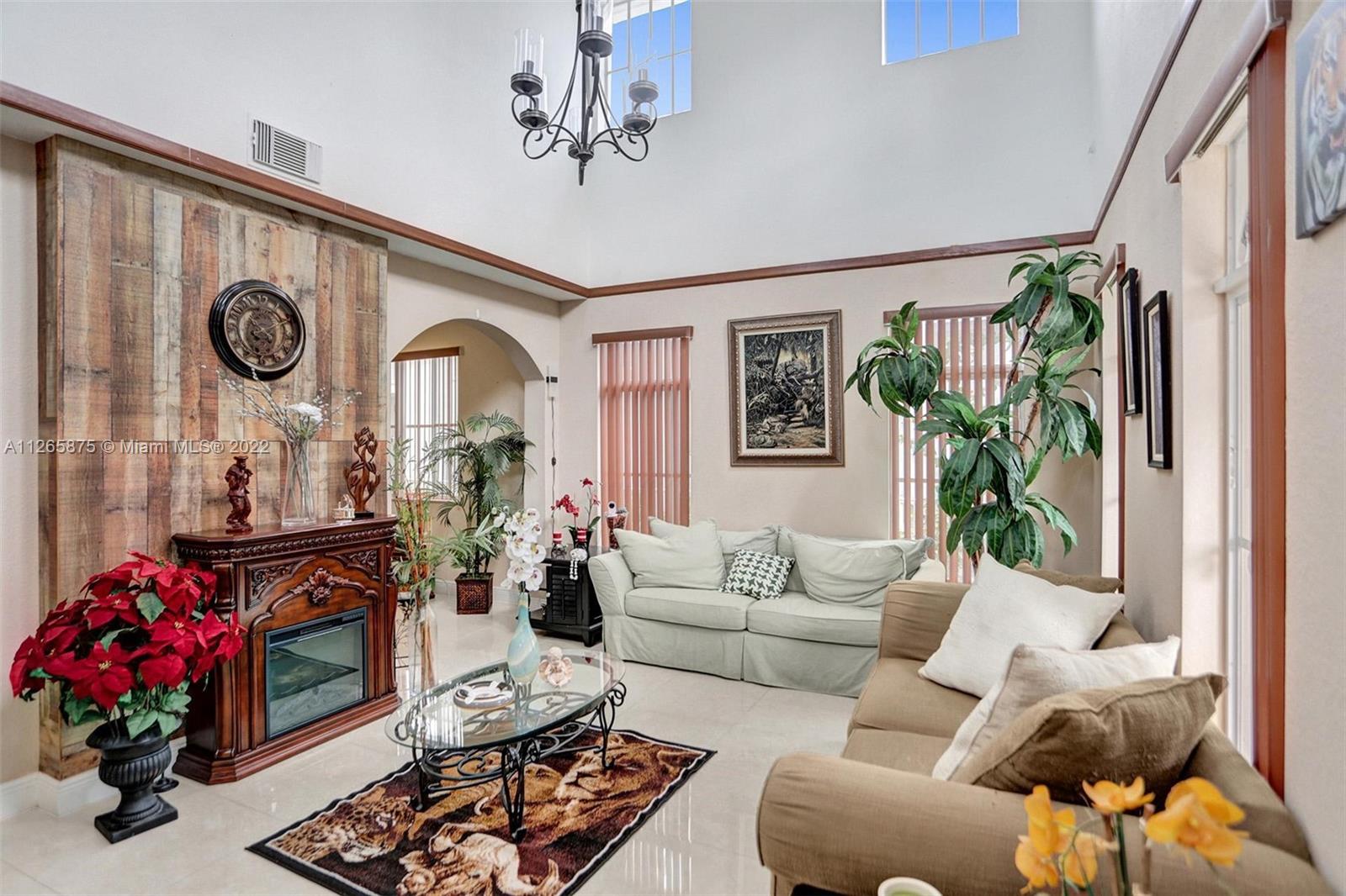 27846 Southwest 142nd Avenue Homestead, FL 33032 - Photo 6 of 56 a living room with furniture and a fireplace