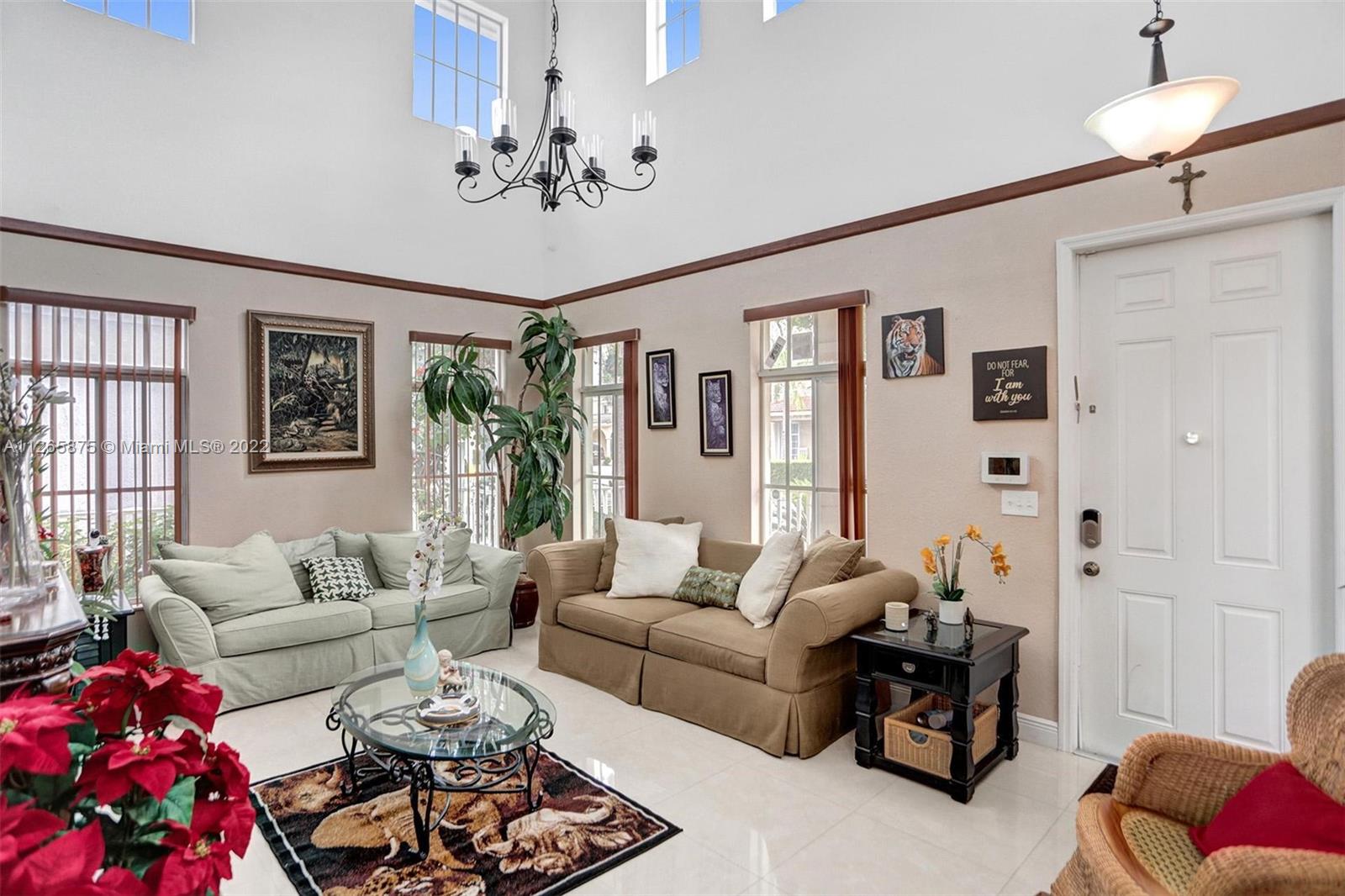 27846 Southwest 142nd Avenue Homestead, FL 33032 - Photo 7 of 56 a living room with furniture or couch and a chandelier
