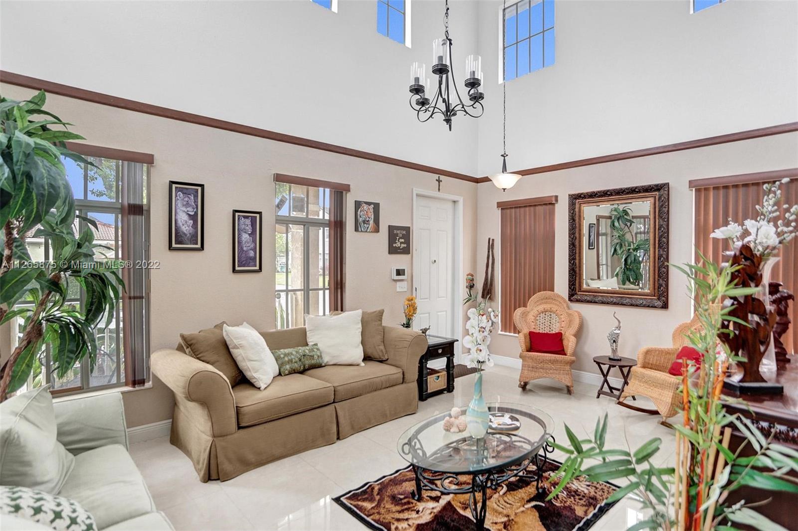 27846 Southwest 142nd Avenue Homestead, FL 33032 - Photo 8 of 56 a living room with furniture and a large window