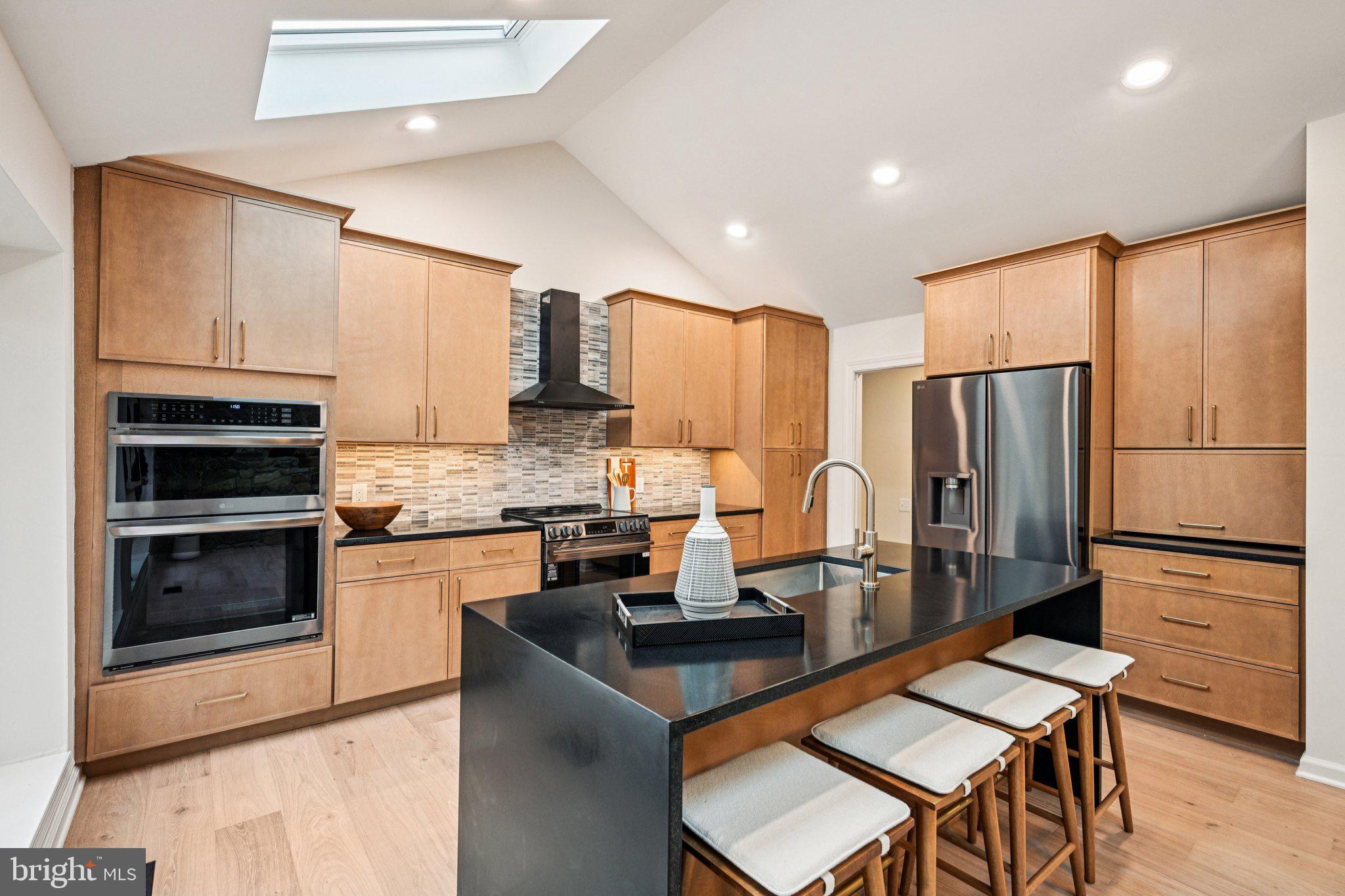 38 Ringfield Road Chadds Ford, PA 19317 - Photo 13 of 50 a kitchen with kitchen island granite countertop stainless steel appliances and refrigerator