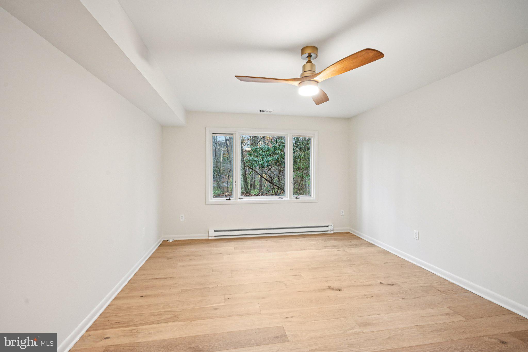38 Ringfield Road Chadds Ford, PA 19317 - Photo 30 of 50 an empty room with wooden floor fan and windows