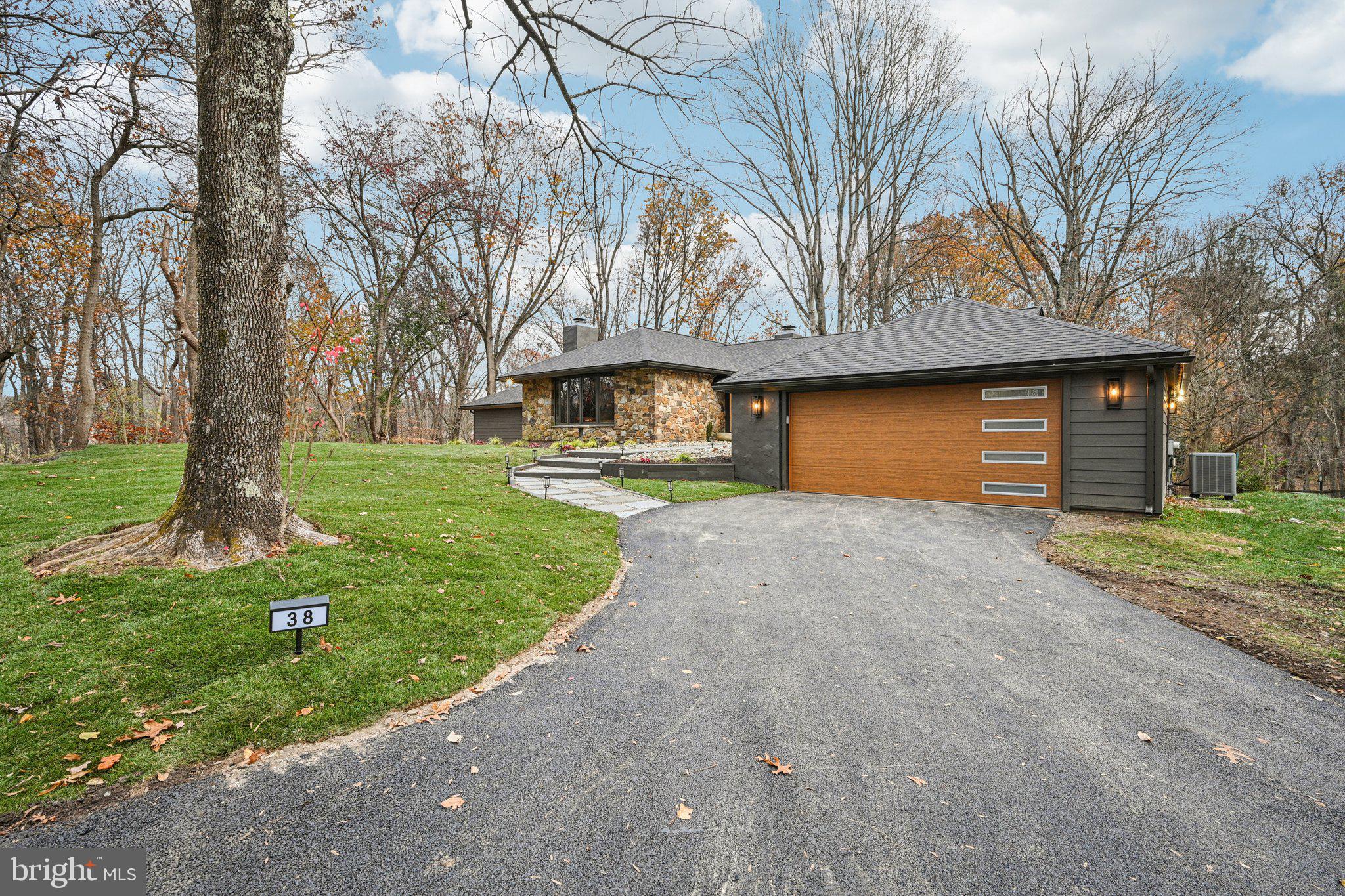 38 Ringfield Road Chadds Ford, PA 19317 - Photo 3 of 50 a front view of a house with a yard and garage