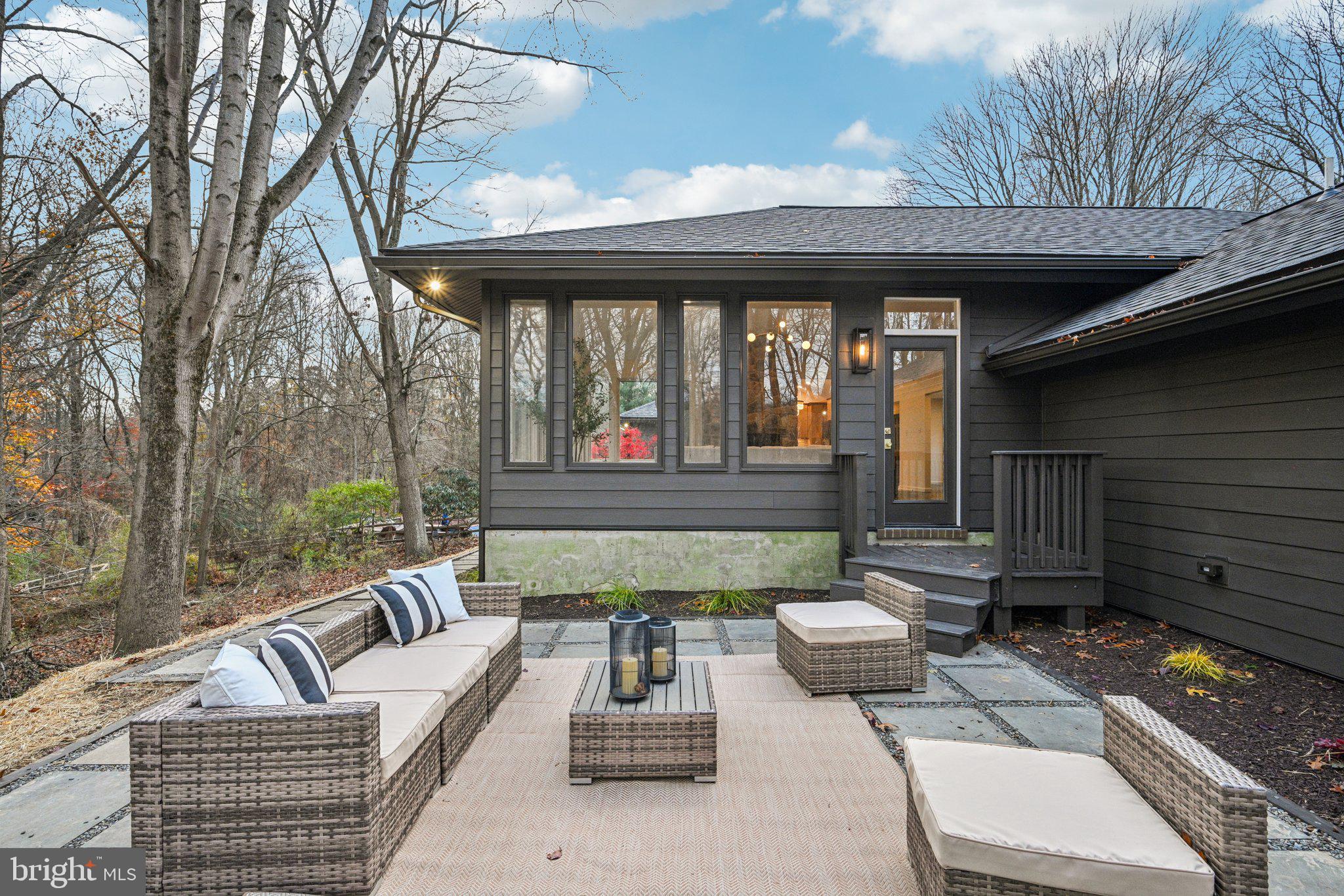 38 Ringfield Road Chadds Ford, PA 19317 - Photo 41 of 50 a view of a patio with couches table and chairs and wooden fence