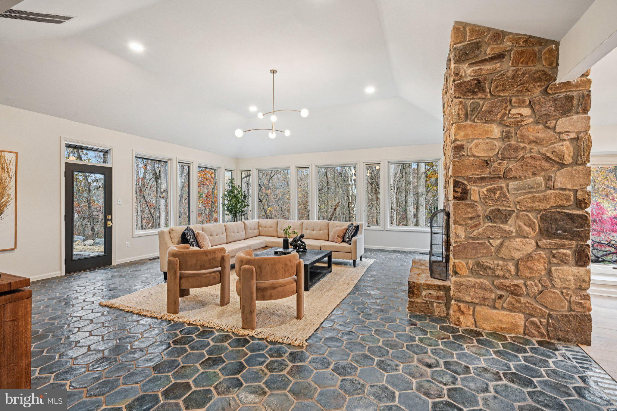 38 Ringfield Road Chadds Ford, PA 19317 - Photo 6 of 50 a living room with fireplace furniture and a floor to ceiling window