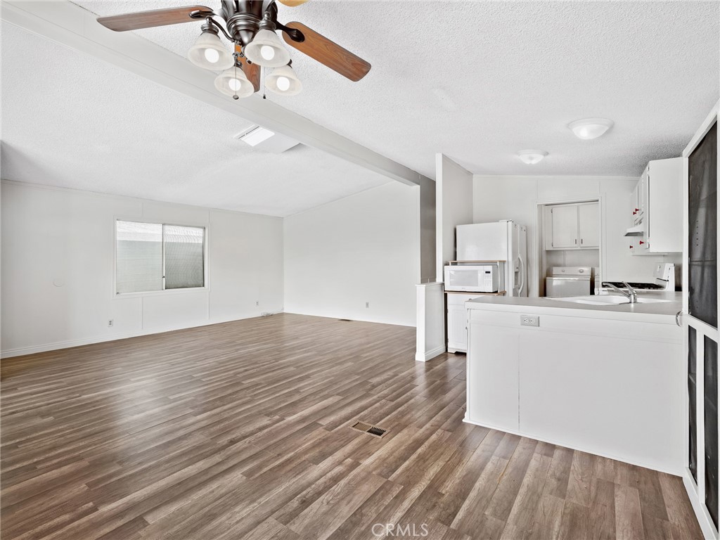 22020 Nisqually Road, Unit 3 Apple Valley, CA 92308 - Photo 11 of 35 a view of a kitchen with wooden floor and a sink