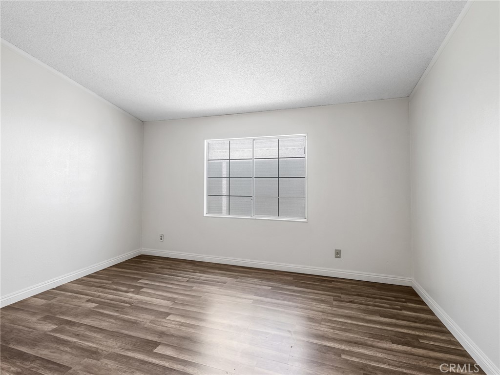 22020 Nisqually Road, Unit 3 Apple Valley, CA 92308 - Photo 15 of 35 wooden floor in an empty room with a window
