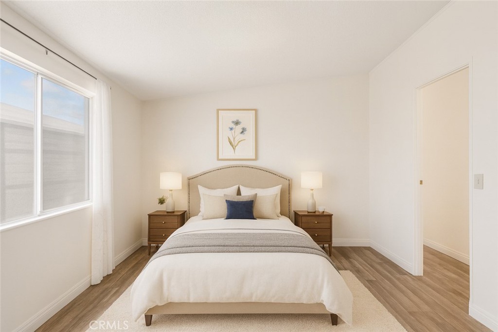 22020 Nisqually Road, Unit 3 Apple Valley, CA 92308 - Photo 16 of 35 a bedroom with a bed and wooden floor