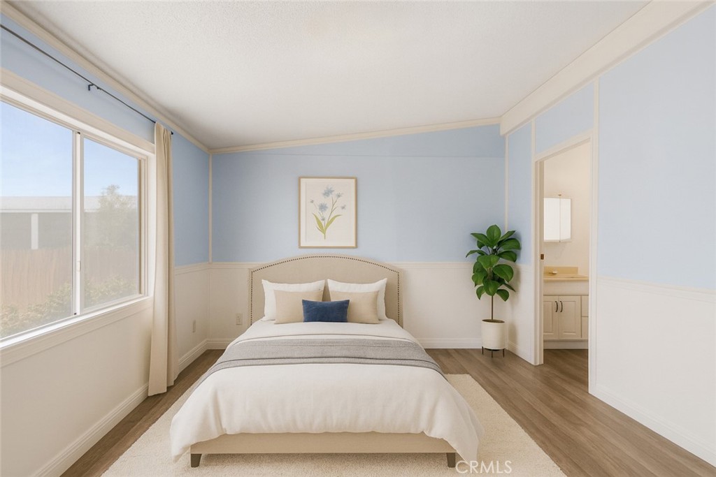 22020 Nisqually Road, Unit 3 Apple Valley, CA 92308 - Photo 21 of 35 a bedroom with a bed and a potted plant