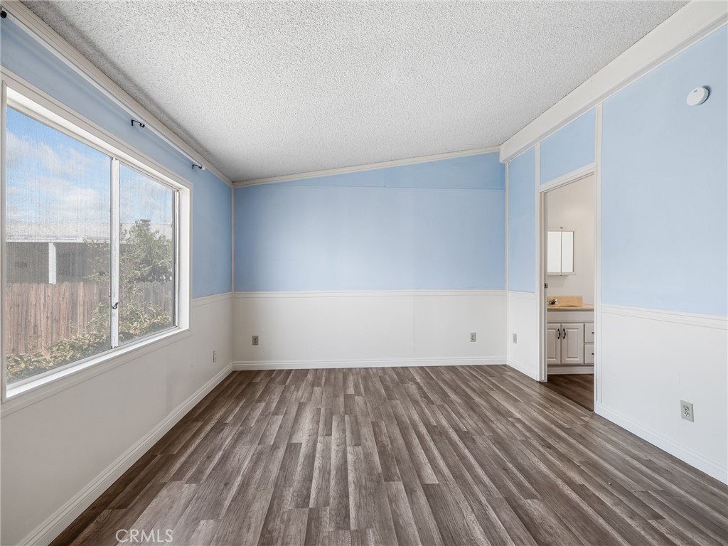 22020 Nisqually Road, Unit 3 Apple Valley, CA 92308 - Photo 22 of 35 wooden floor in an empty room with a window