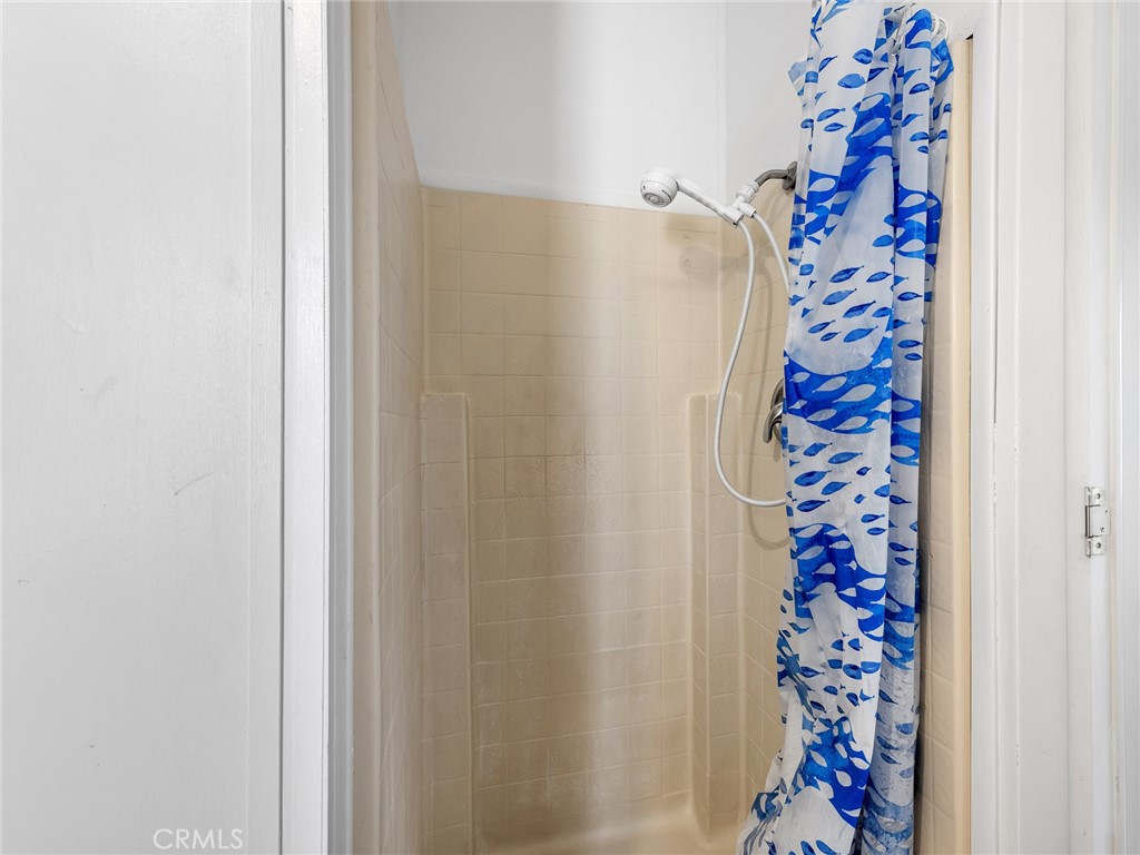 22020 Nisqually Road, Unit 3 Apple Valley, CA 92308 - Photo 25 of 35 a bathroom with a shower curtain and window