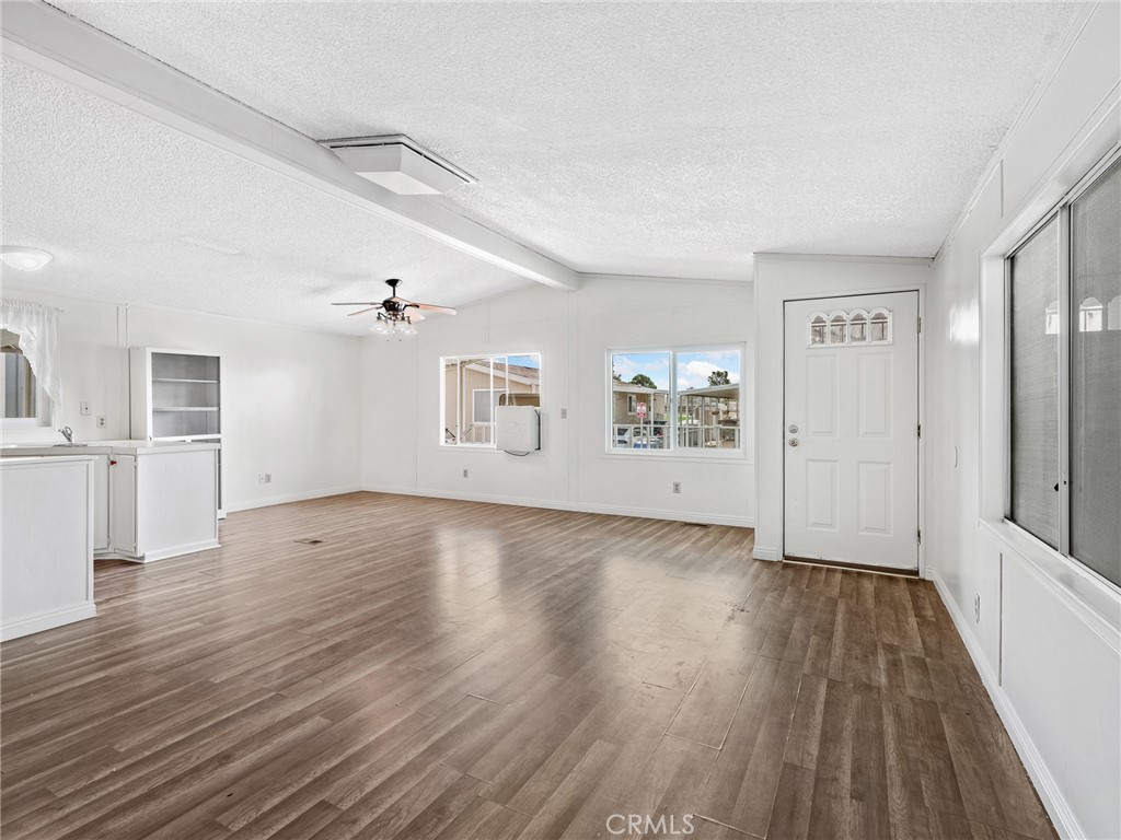 22020 Nisqually Road, Unit 3 Apple Valley, CA 92308 - Photo 8 of 35 a view of an empty room with wooden floor and a window