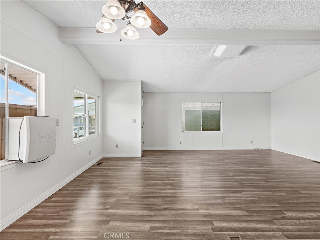 22020 Nisqually Road, Unit 3 Apple Valley, CA 92308 - Photo 9 of 35 a view of an empty room with wooden floor and a window