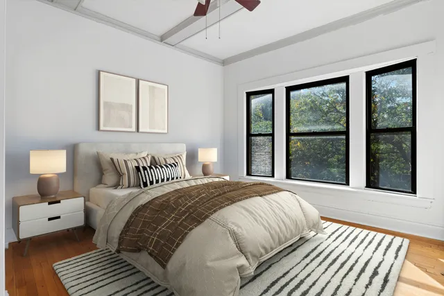 a bedroom with a large bed and a large window