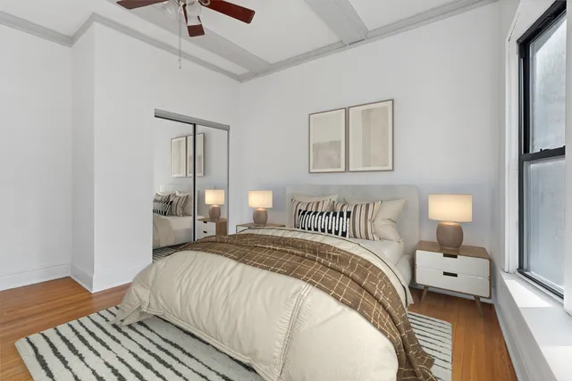 a bedroom with a bed and a night stand