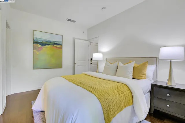 a bedroom with a bed and a lamp