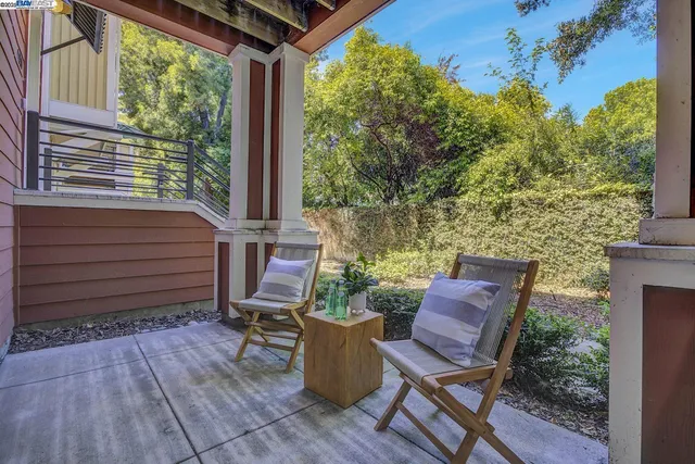 a view of a chair and table in backyard of the house