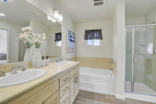 a bathroom with a bathtub sink and mirror