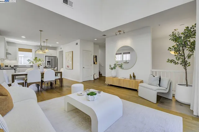 a living room with furniture and a large mirror