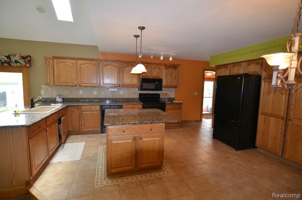 8620 Eaton Road Davisburg, MI 48350 - Photo 15 of 55 GRANITE ISLAND IN SEA OF BEAUTIFUL TILE AND HARDWOOD CABS