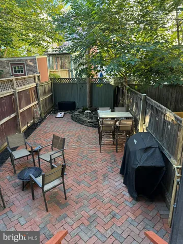 a view of backyard with deck and outdoor seating