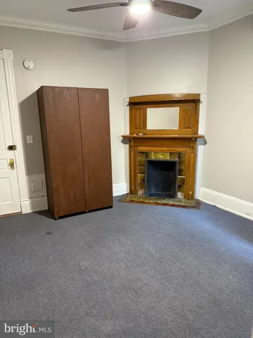a view of empty room with fireplace and cabinet