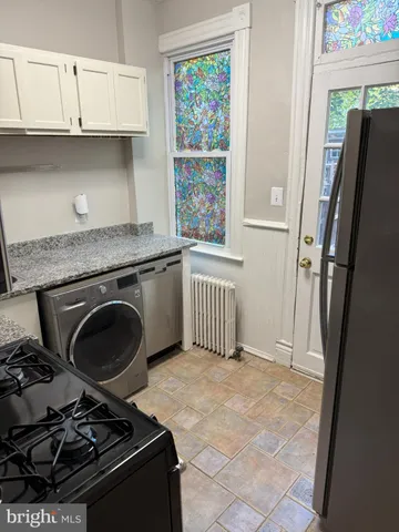 a kitchen with a stove and a refrigerator