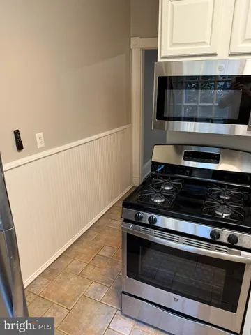 a stove top oven sitting inside of a kitchen