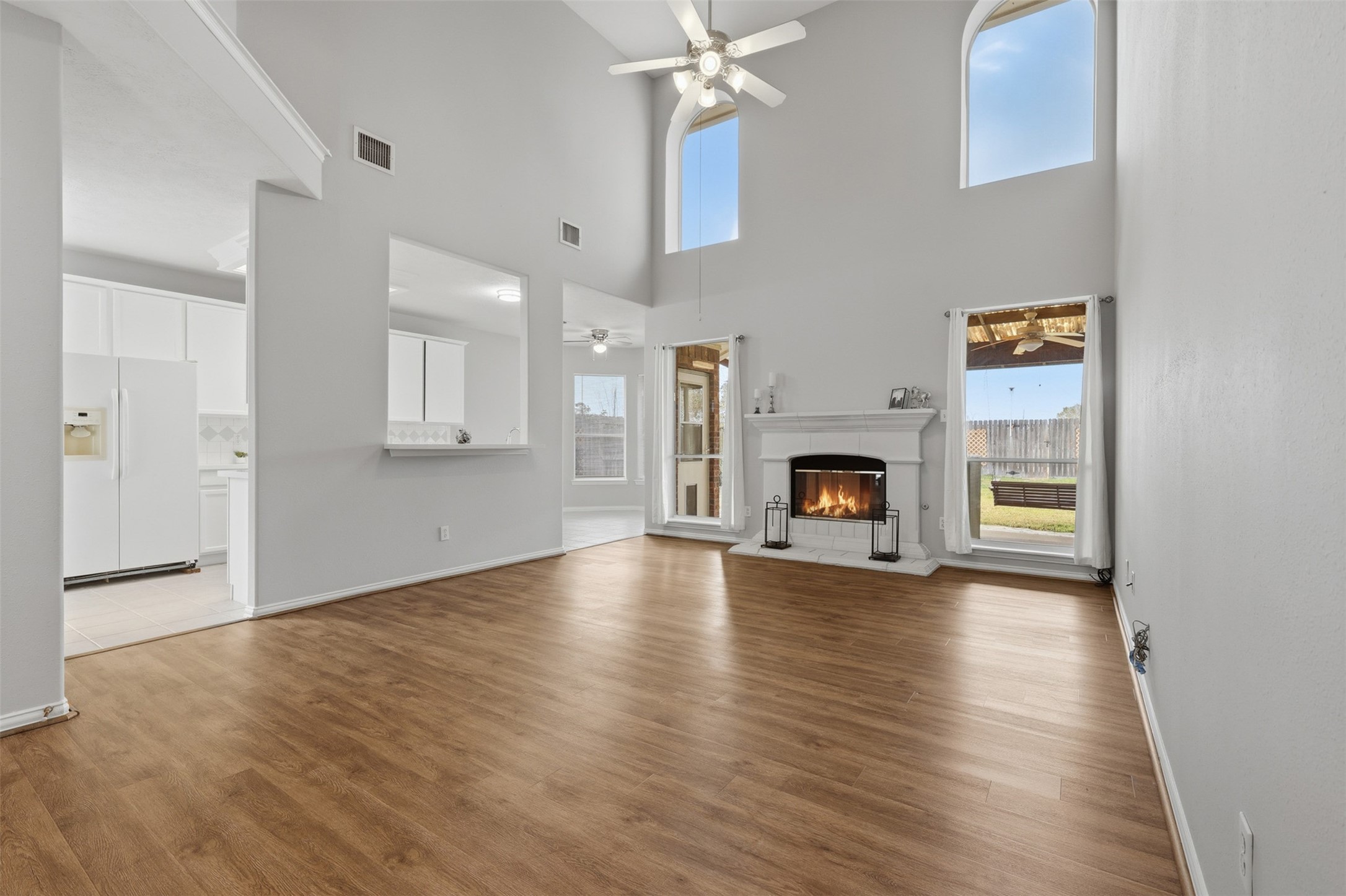 2202 Melanie Park Drive Spring, TX 77388 - Photo 11 of 26 an empty room with fireplace wooden floor and windows