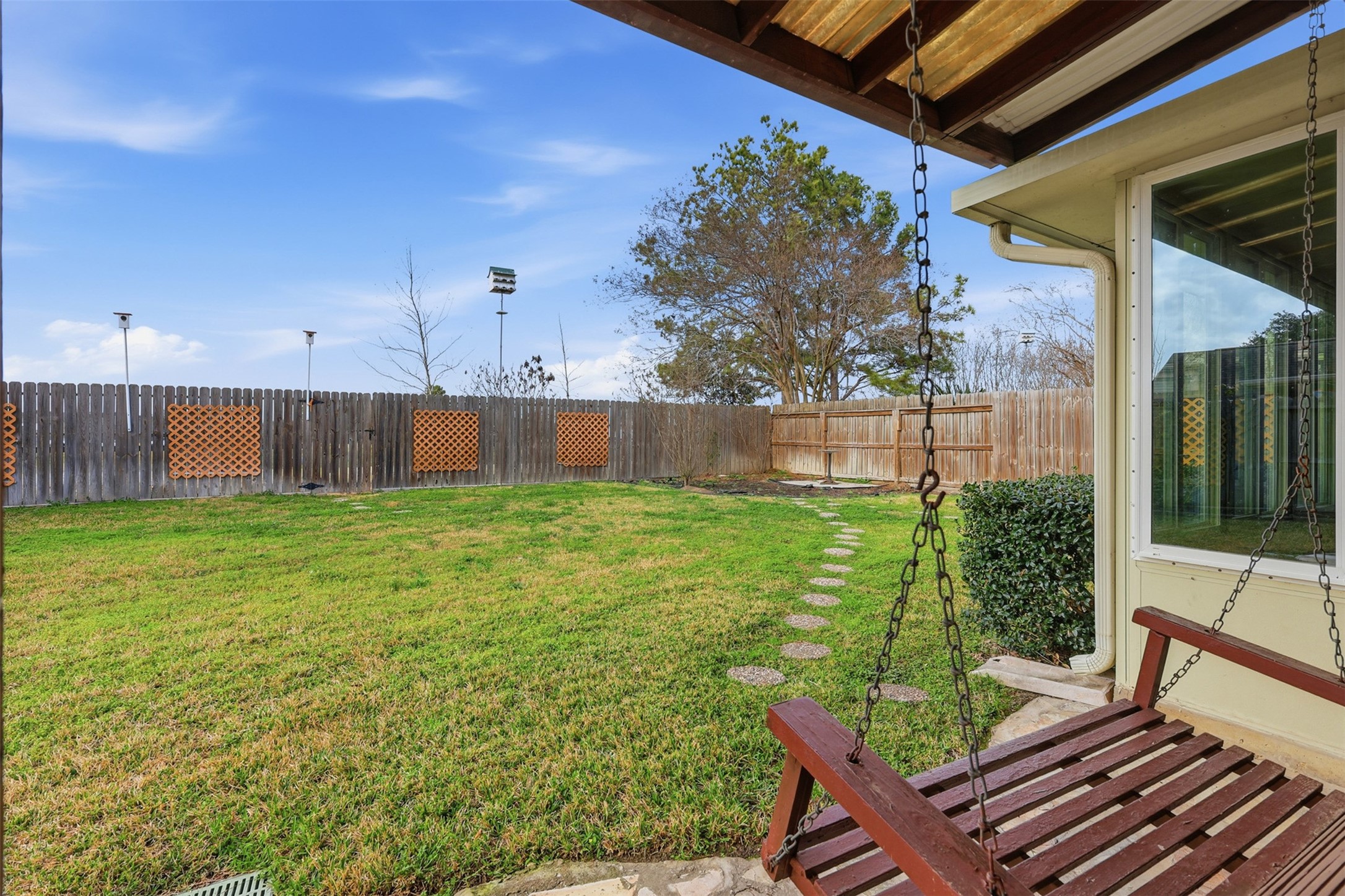 2202 Melanie Park Drive Spring, TX 77388 - Photo 21 of 26 a view of a backyard with table and chairs and wooden fence